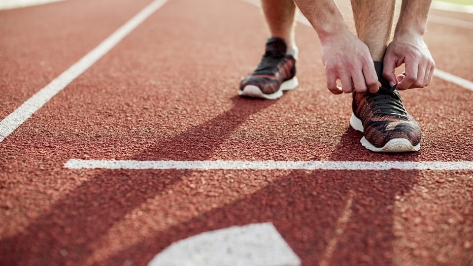 shoes at the start line of a running track