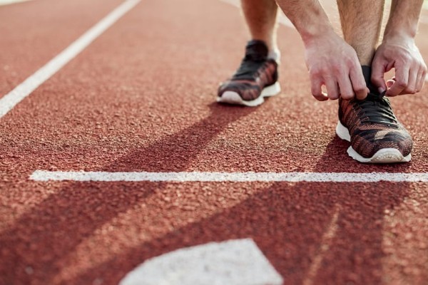 shoes at the start line of a running track